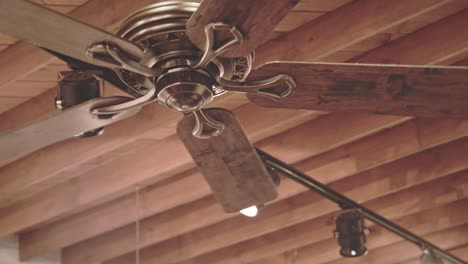 Ceiling-fan-on-wooden-roof.-Wooden-roof-background.-Cooling-fan